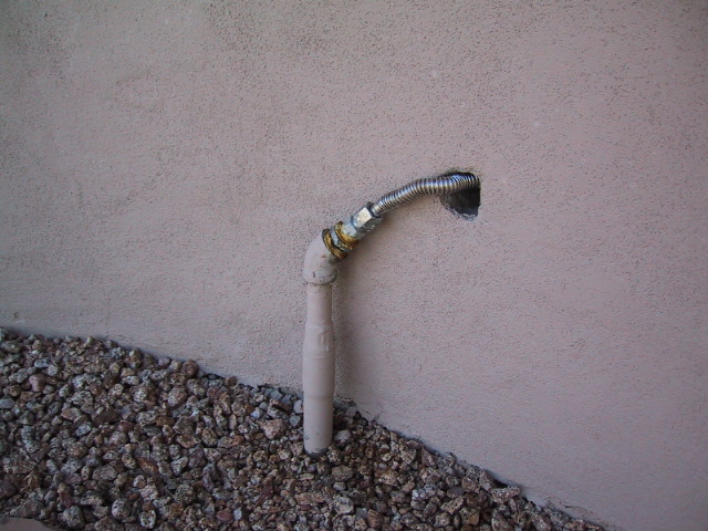 Improper gas flex piping through wall